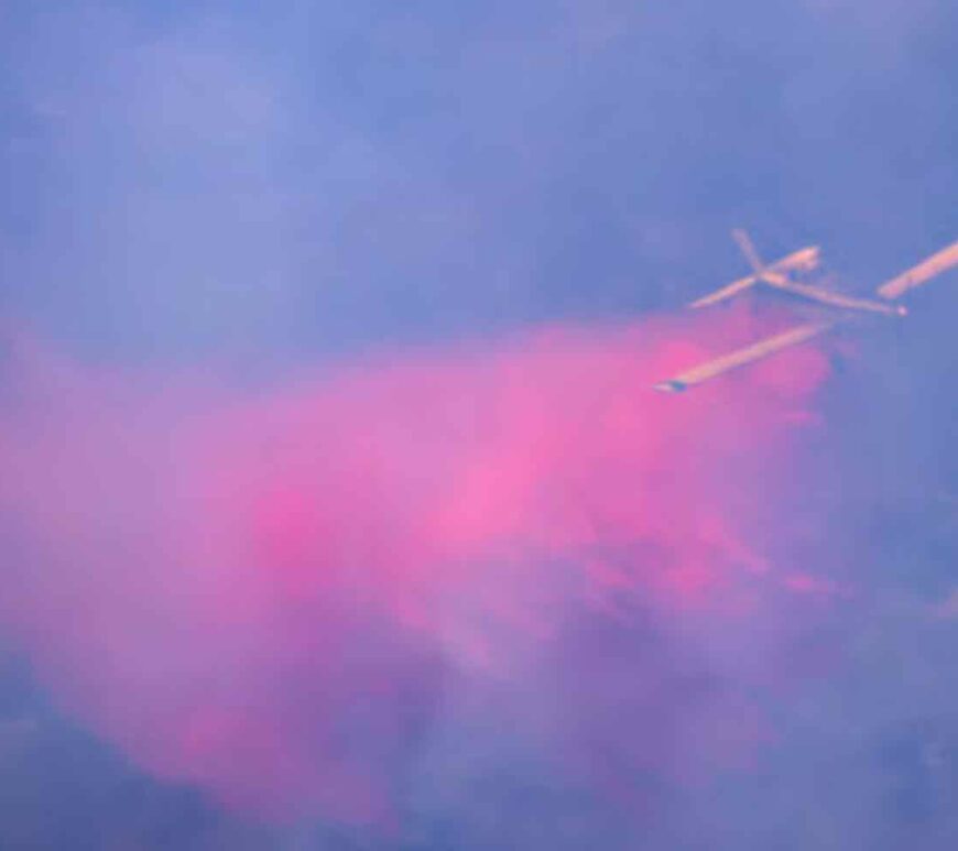 Firefighter plane drops fire retardant on burning trees as it flies through smoke, amid cross-border hostilities between Hezbollah and Israel, in northern Israel.