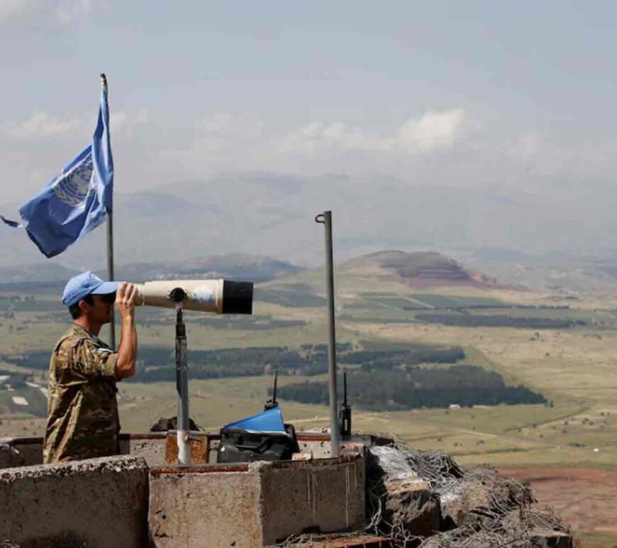 United Nations Truce Supervision Organisation military observer uses binoculars near the border with Syria in the Israeli-occupied Golan Heights, Israel.