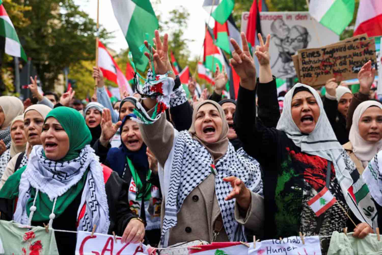 pro-Palestinian-demonstrators Protesters react holding Lebanese and Palestinian flags during a demonstration in solidarity with Palestinians in Gaza, ahead of the October 7 attack anniversary, amid the Israel-Hamas conflict, in Berlin, Germany.