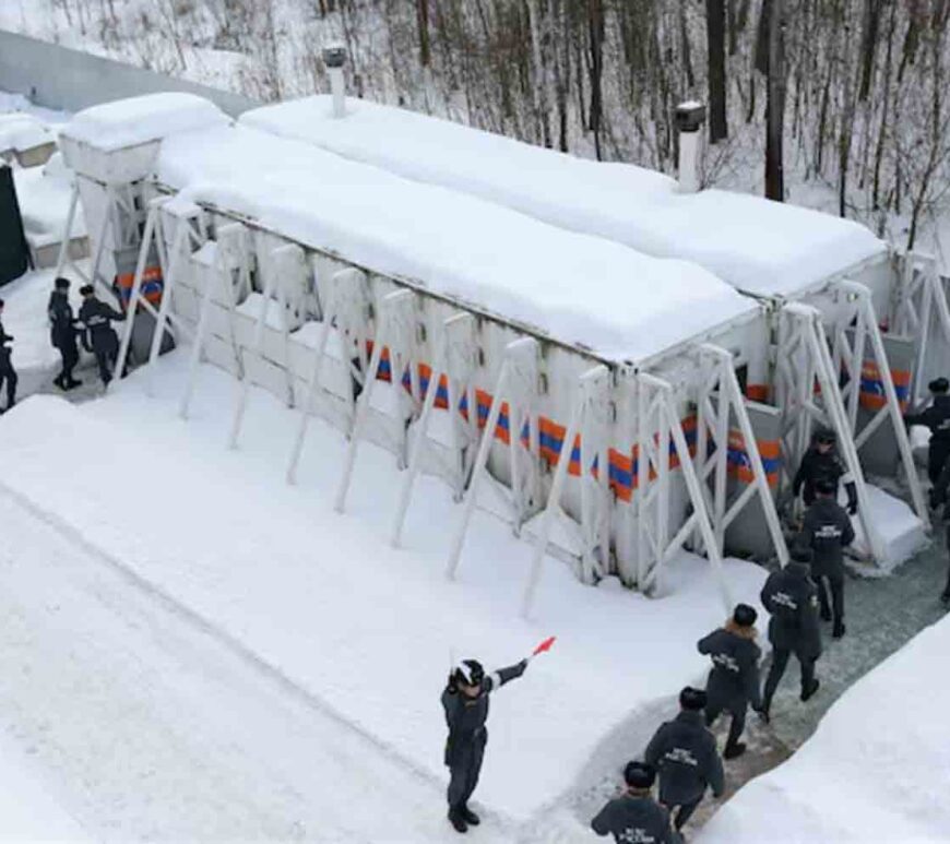 Emergency personnel walk into radiation-resistant mobile bomb shelters in Nizhny Novgorod region, Russia February 10, 2023. Russian Scientific Research Institute for Civil Defence and Emergencies of EMERCOM۔